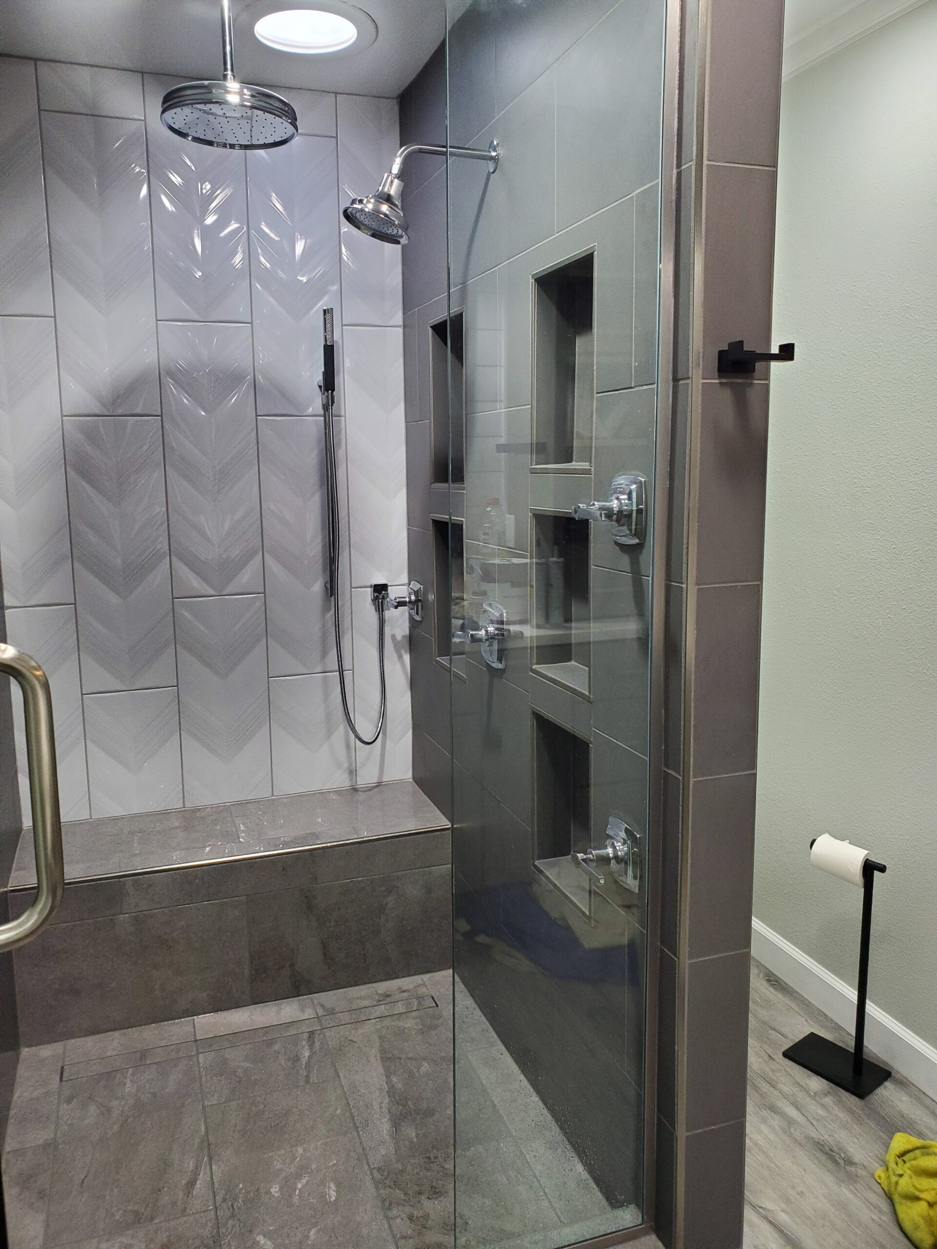 Completed tiled walk-in shower remodel with new fixtures by Prime Plumbing in the Billings, MT area