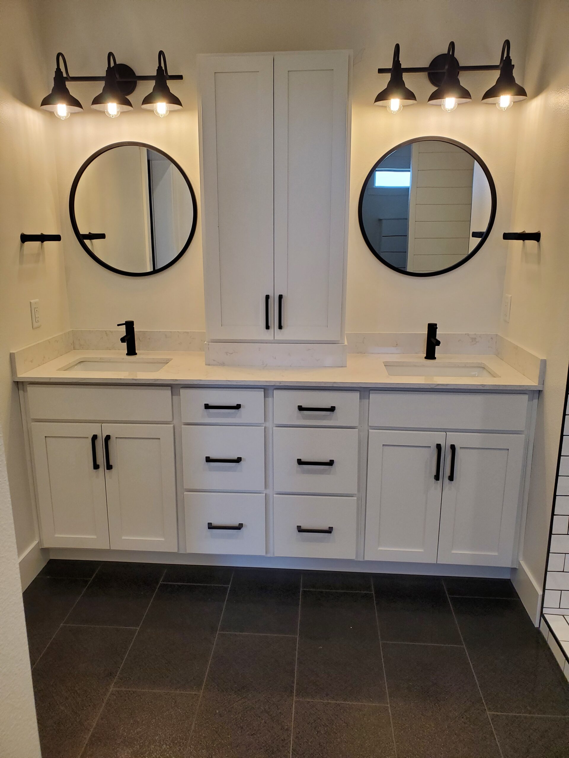 Finished bathroom featuring a custom double vanity and precision plumbing installation