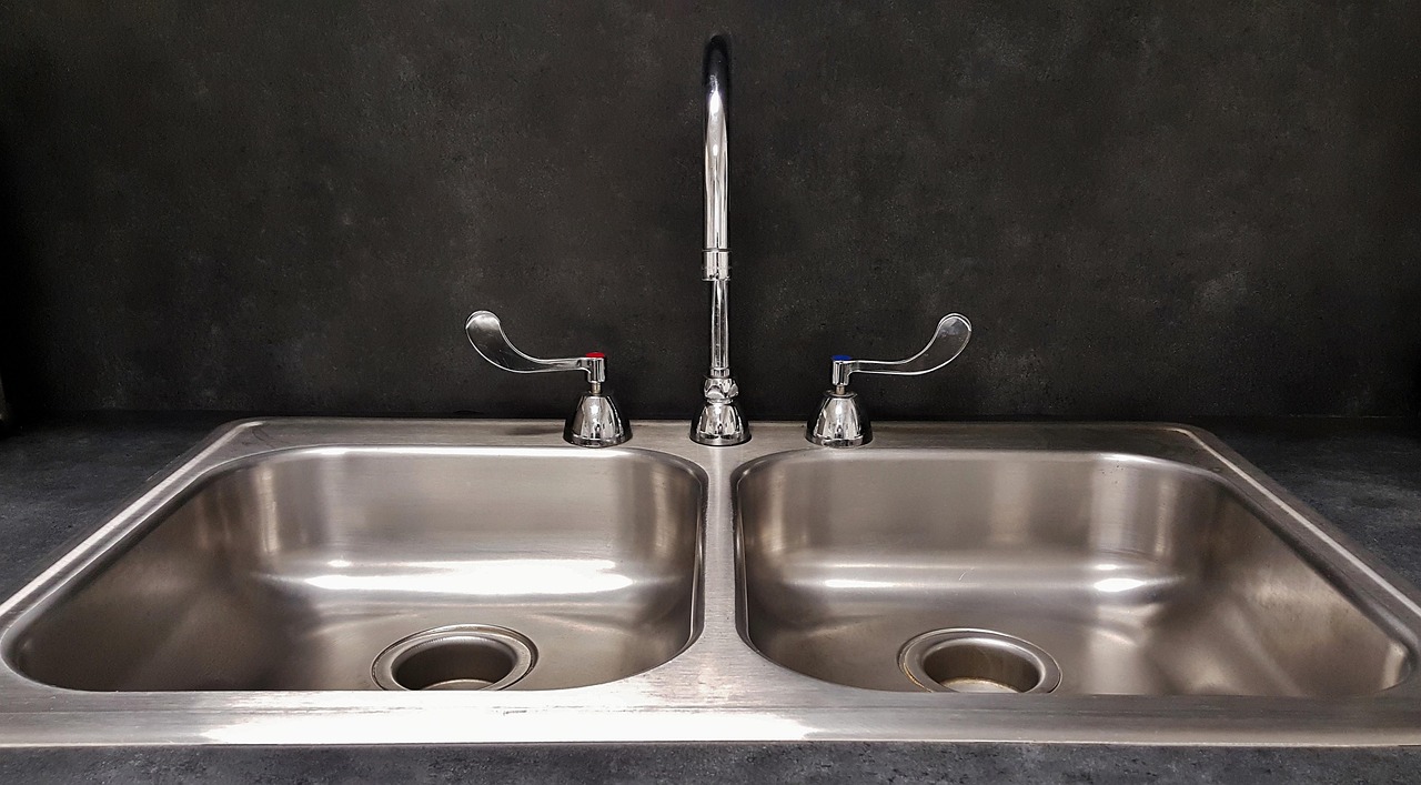 Double-basin kitchen sink with disposal drain openings, the kind Prime Plumbing services in Billings, MT
